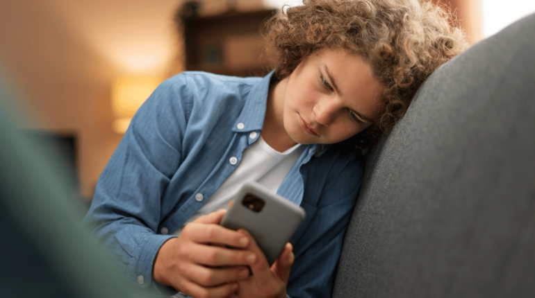 Teen boy looking at smart phone